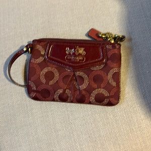 COACH, cranberry and gold in color, small zip